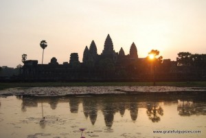 Watch the sun come up over Angkor Wat.