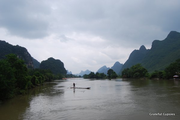 A fisherman chases a duck in Yangshuo.