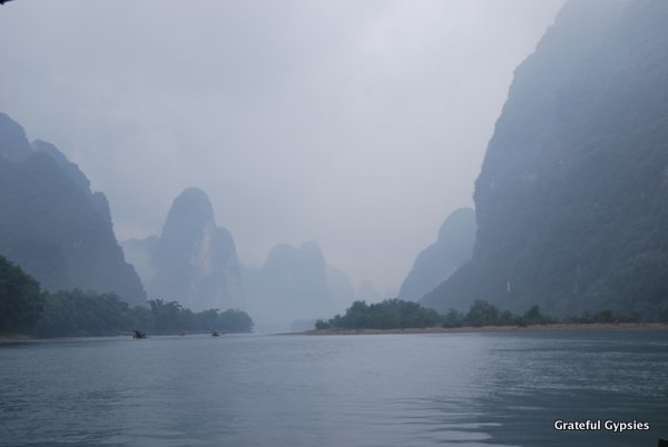 The morning mist covers the karst peaks on a Li River cruise.
