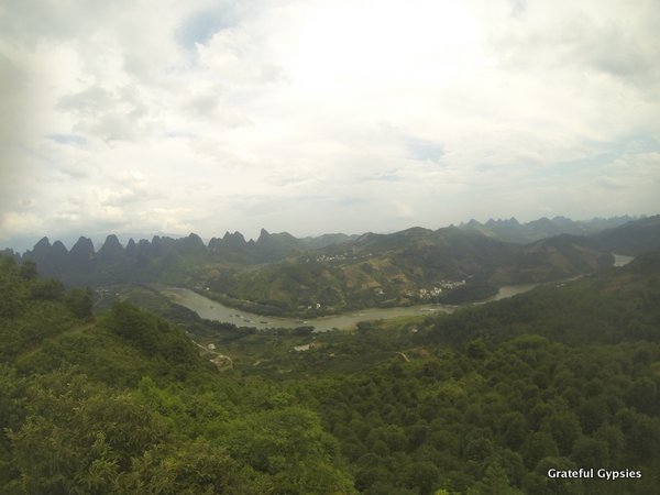 Rent a motorbike and cruise to viewpoints like this high above the Li River.