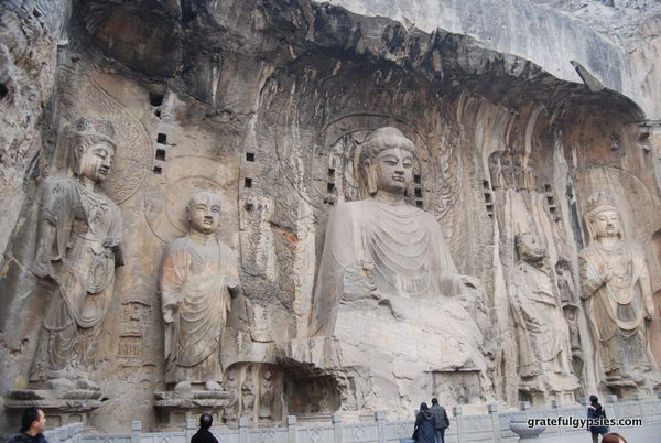 Massive Buddhas carved into the rocks.