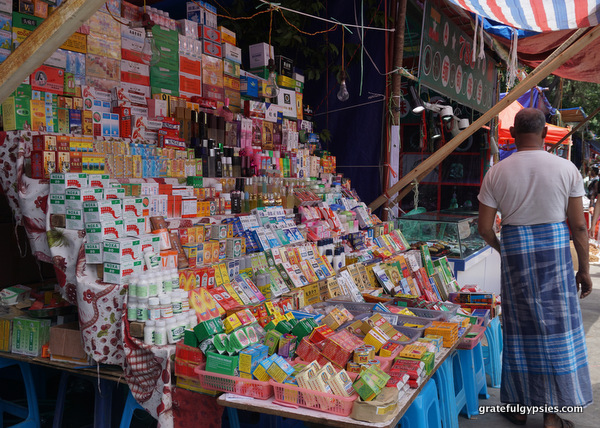 Burmese shopkeep selling traditional medicine.