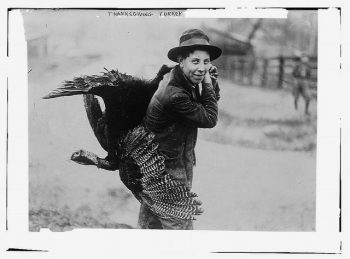 Woman with a turkey for Thanksgiving.