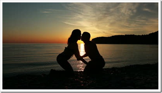 stock-footage-couple-on-the-shore-of-the-sea-romantic-couple-at-sunset-two-people-in-love-at-sunset-man-and