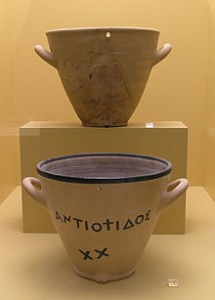 A display of two outflow water clocks from the Ancient Agora Museum in Athens. The top is an original from the late 5th century BC. The bottom is a reconstruction of a clay original.Courtesy of Wikicommons.