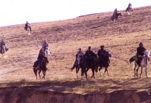 Afghani and United military forces on horseback in Afghanistan, 2001. Courtesy of WikiCommons.