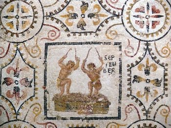 Two men crushing grapes on the September panel from the 3rd-century mosaic of the months at El Djem, Tunisia (Roman Africa):[1] the vintage is a characteristic activity of the month in Roman art. Courtesy of Ad Meskens and Wikimedia Commons.