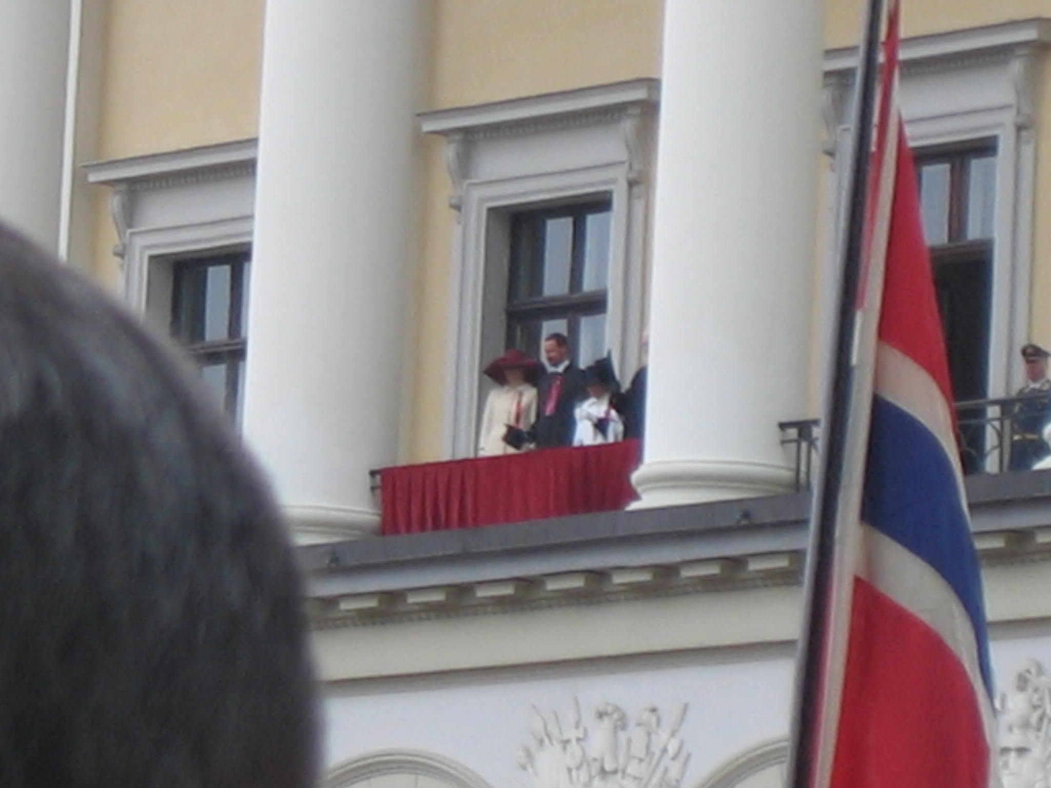 The Royal family waving from the palace on Karl Johans Gate