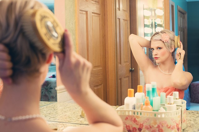 woman brushing her hair in front of a mirror