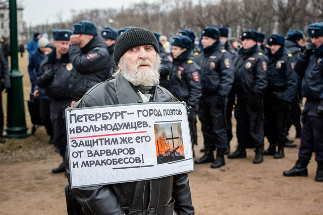 Man at a protest in St. Petersburg carrying a sign