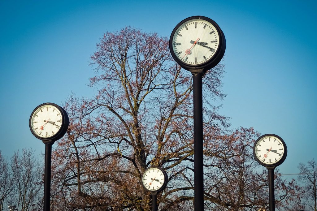 four clocks in a park