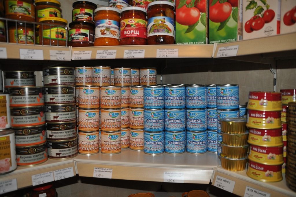 condensed milk cans on shelves in a Russian store