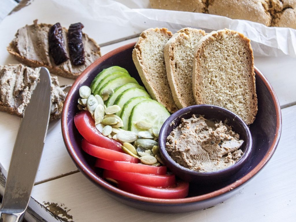 food platter with bread, vegatables, and pâté
