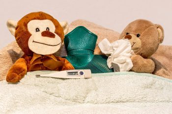 plush toys in bed with a thermometer