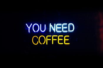 neon sign saying "you need coffee"