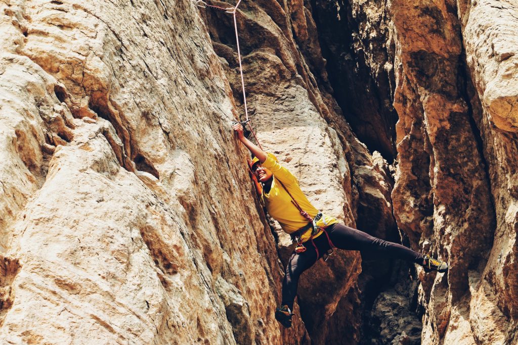 woman climbing rocks