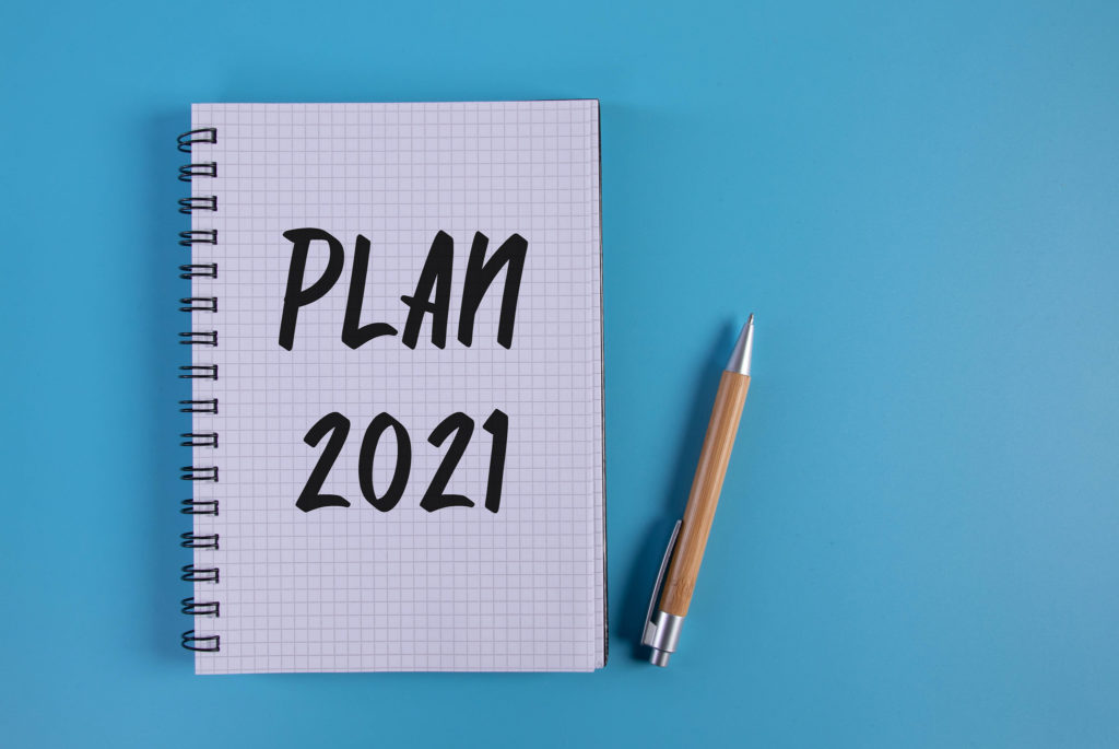 Pen and notebook with Plan 2021