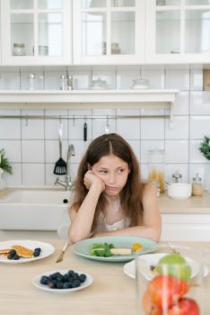 girl in front of the plate of food